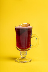 Red Fruit Drink with Orange and Cinnamon Stick Garnish