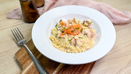 Creamy risotto embraces woodland mushrooms and vibrant herbs, perfect for International Risotto Day or a gourmet autumn feast