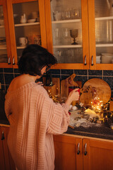 a woman is baking christmas cookies in the kitchen,