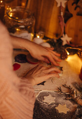 the hand of a woman baking Christmas cookies