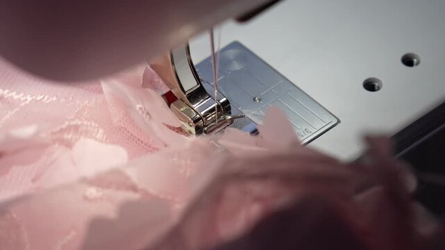 Close-up of needlework on pink fabric petals at home for diy fashion project