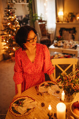 A woman is setting the table for Christmas dinner