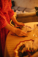 the hand of a woman setting the table for Christmas dinner