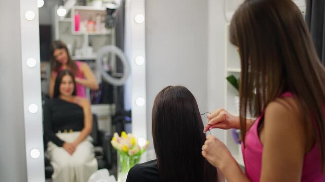 A master hairdresser checks the condition of the client's hair before the procedure. High quality 4k footage