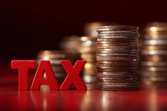 A pile of coins and a red sign that says tax
