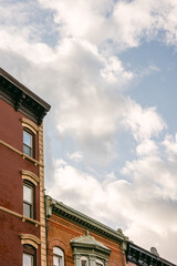 Historic buildings under a cloudy sky in a vibrant neighborhood during the afternoon