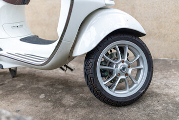 Detailed Close-Up of White Scooter Wheel