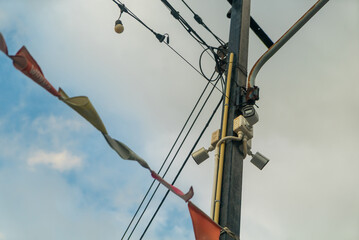Obraz premium Colorful Flags and Utility Pole with Cables