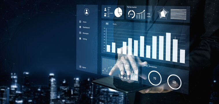 A business professional interacts with a digital dashboard displaying graphs and performance metrics, set against a modern urban skyline at night. Impute
