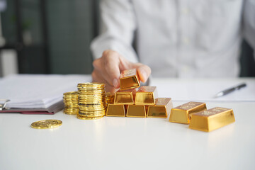Gold Trading Businessman invest in trading gold, calculating profit price of gold in the market.