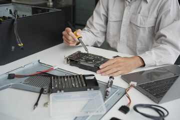 Closeup hand of computer hardware technician dissemble and  fixing computer PC.