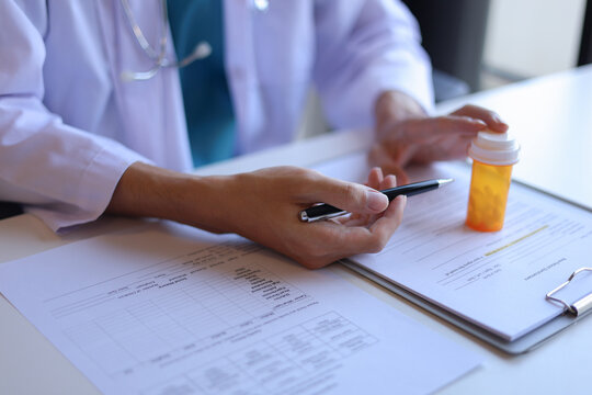 Doctor or General practitioner explain to patient how to use prescribed medicine correctly by explain dosage, frequency, and timing.
