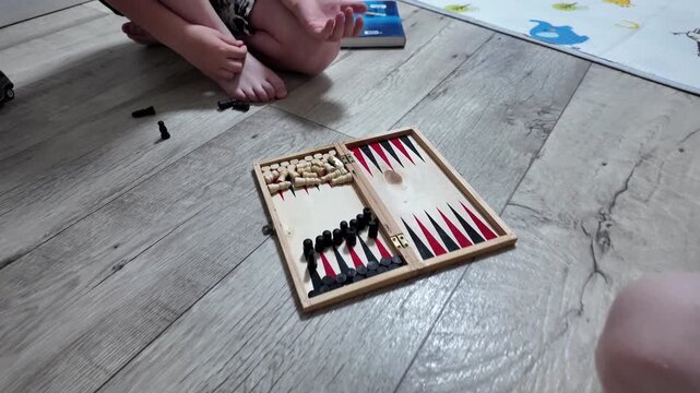 Cozy home environment featuring father and child engaged in game of backgammon