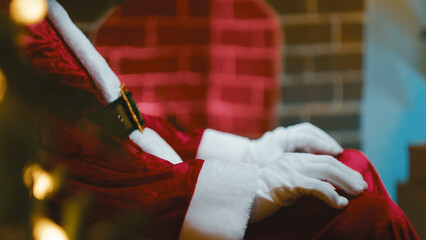 Santa's Hand Ticking on Leg Waiting for the Time to Leave for Christmas