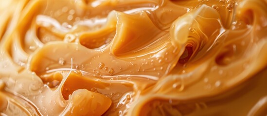 Smooth, creamy peanut butter spread on a surface. The texture is rich and glossy, showcasing its deliciousness and versatility in cooking and baking.