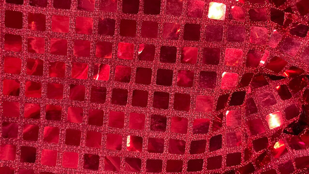 Vibrant red sequin fabric macro background. Square glitter texture for party, fashion, and celebration designs