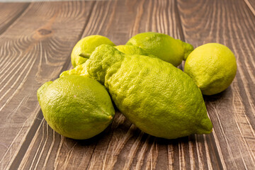 Fresh green lemons lying on wooden boards