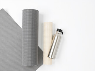 Yoga Mats and Stainless Bottle on Minimal White Background