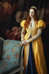 A red-haired woman wearing a historically styled gold gown with puffy sleeves