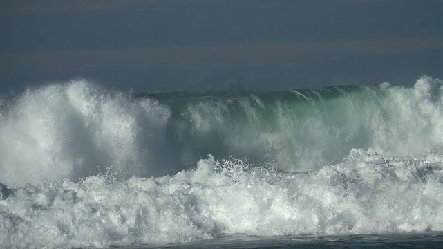big wave green water, sea foam, blue sky