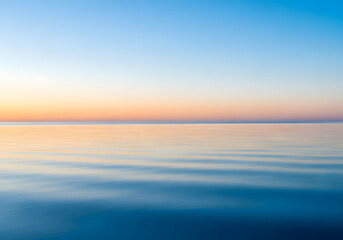 Fototapeta premium A serene ocean at sunset, showcasing a gradient of colors in the sky