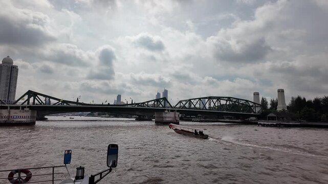 BANGKOK, THAILAND - 1ST OCTOBER 2024: View from front of tour boat as it approached Phra Phutthayotfa Bridge on the Chao Phraya River in Bangkok
