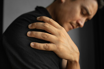 Man Holding Painful Shoulder – Injury, Strain, or Muscle Tension