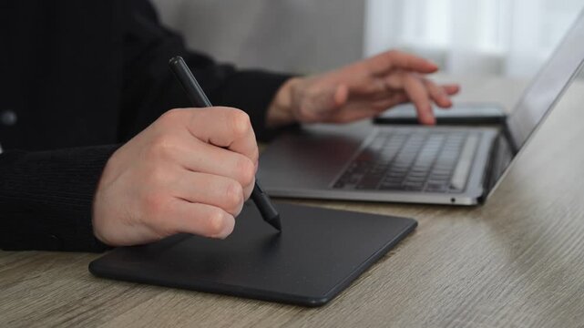 An office worker works on a laptop and uses a digital graphics tablet.
Digital artist or logo illustrator for brands and businesses.
Business, illustration, stylus, business, drawing, art