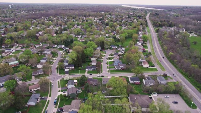 Overhead aerial view and drone shot of Westerville, OH outside Columbus, Ohio suburban suburb neighborhood homes in rows along Sunbury Road and car streets leading through neighboring homes buildings