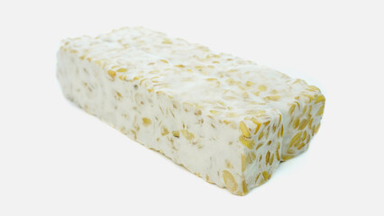 Tempeh or soybean tempeh, a source of vegetable protein made from soybeans that are boiled and given special yeast through a fermentation process until they form a solid, isolated on white background