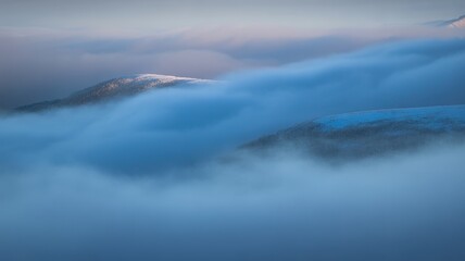 Fog over winter mountain peaks