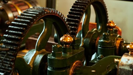 Close-up view of an old industrial steam engine operating indoors