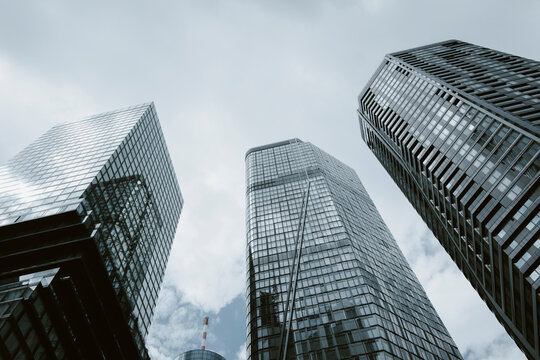 Clean architecture of glass skyscraper towers shaping the skyline of Frankfurt Germany, conveying modern corporate finance clarity with bright reflection planes and minimalist perspective