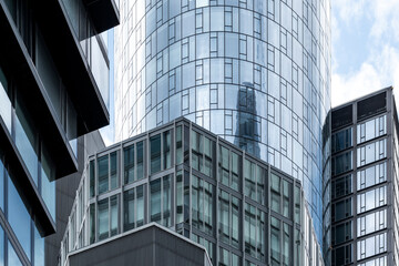 Contemporary skyscraper architecture in Frankfurt Germany showing bold corporate finance ambition through modern skyline lines and layered reflection surfaces in a strong perspective