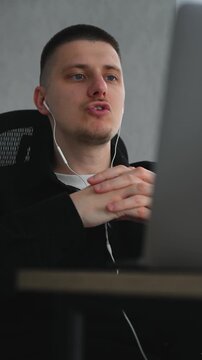 A service center employee communicates with colleagues during an online conference call.
Remote work at a computer.
A call center operator sits at a desk in an office, communicating with clients remot