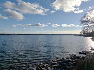 White clouds over a river on a fall day
