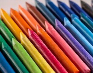close up view of numerous colorful sharpened crayons arranged tightly in rows forming vibrant
