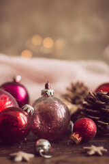 vintage red glass baubles with pinecones on rustic wooden table creating nostalgic christmas decor concept of holiday styling and retro festive mood