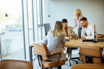 Business team reviewing data in office setting during daytime meeting