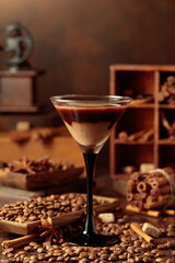 Cream and coffee cocktail on a table with scattered ingredients.