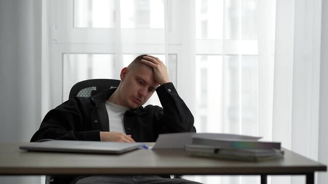 Stress and fatigue at work.
A man experiences a nervous breakdown due to fatigue and lack of days off.
Office work and a man's negative emotions.
Problems at work.
Deadlines, stress, mood, office