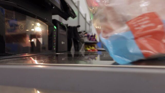 Man operates Self-service Checkout, Scanning His Items and Placing Them in Bags. Man Puts Groceries Into Bags at Self-checkout Counter in Store. Greenville, SC, USA - August 30, 2025.