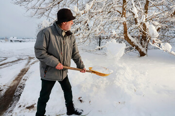Man is removing snow after the snowfall.