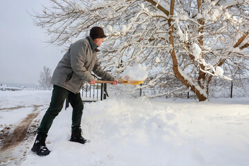 Man is removing snow after the snowfall.