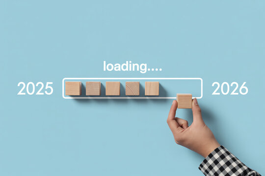 Loading progress bar 2025 2026 year wooden blocks hand completing business goal achievement future planning strategy development.