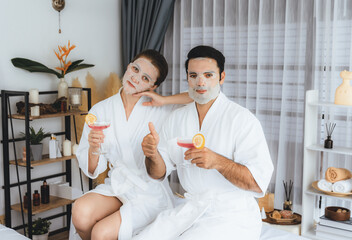 Serene modern daylight ambiance of spa salon, couple customer indulges in rejuvenating with facial skincare mask. Facial skin treatment and beauty cosmetology procedure for face. Quiescent