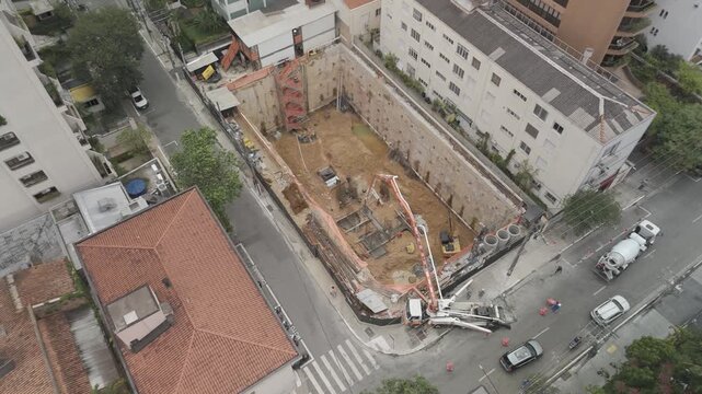 Aerial Rotating Shot of a Building Construction Site with Deep Foundation Excavation