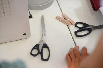 Close-up of a workbench with tailor's scissors and sewing tape