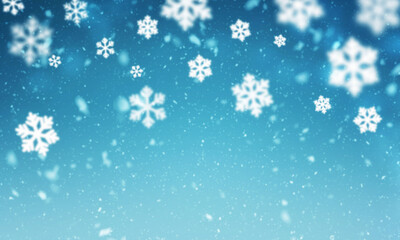 Blue winter background with falling snowflakes blurred
