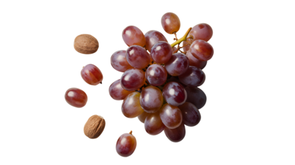 A ripe bunch of red grapes with scattered individual grapes and seeds isolated on transparent background
